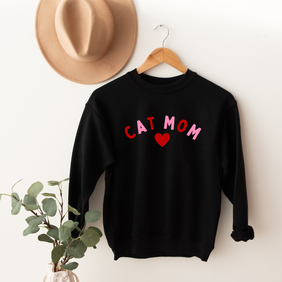 "Cat Mom Heart design centered on black sweater."