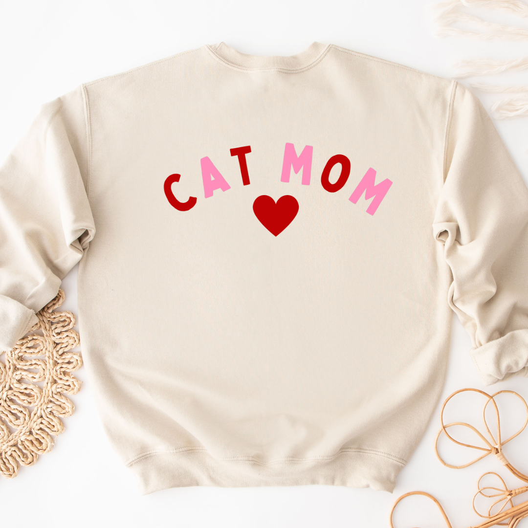 "Cat Mom Heart design centered on natural sweater." 