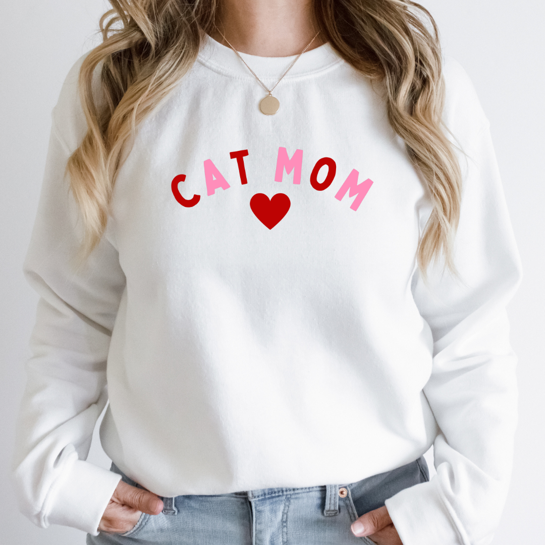 "Cat Mom Heart design centered on white sweater."