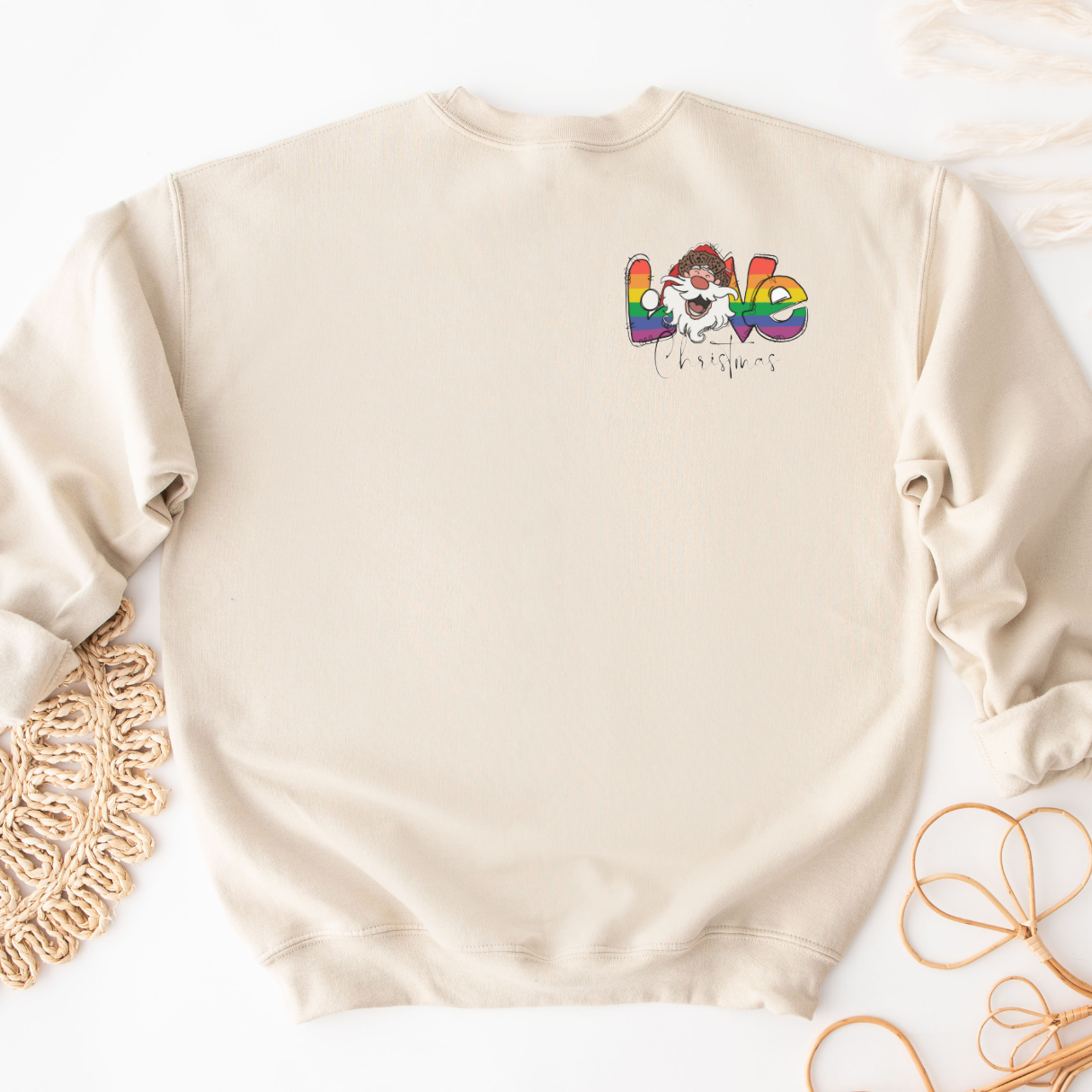 "Pride love Christmas text design centered on natural sweater."