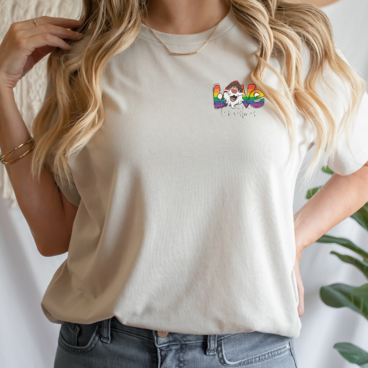 "Pride love Christmas text design centered on natural t-shirt."