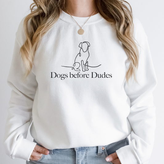 "Dogs before dudes text and graphic design centered on white sweater."