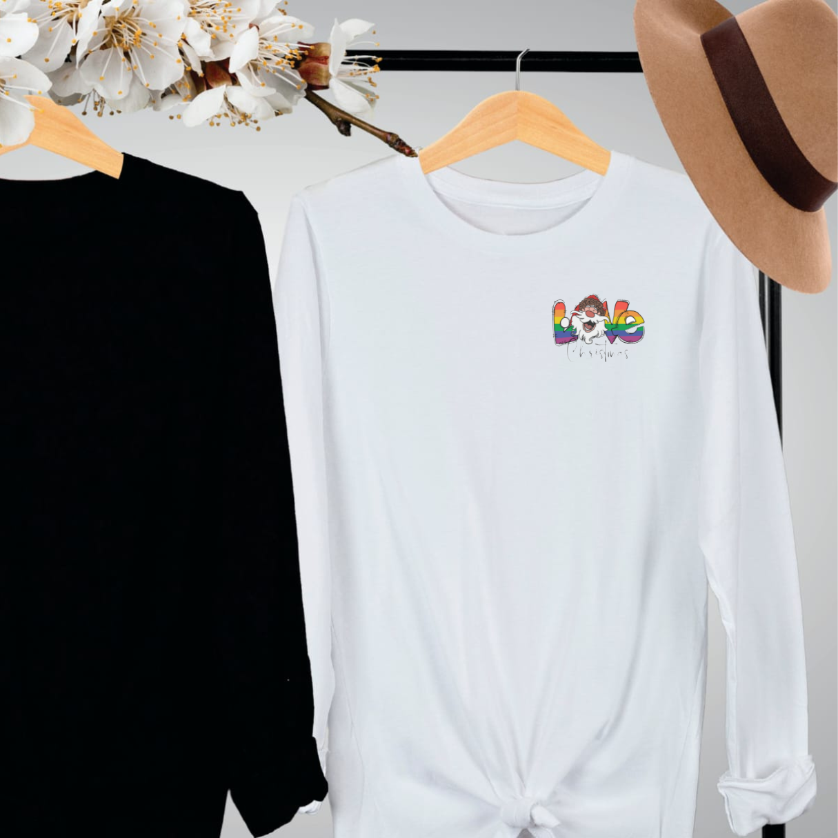 "Pride love Christmas text design centered on white long sleeve shirt."