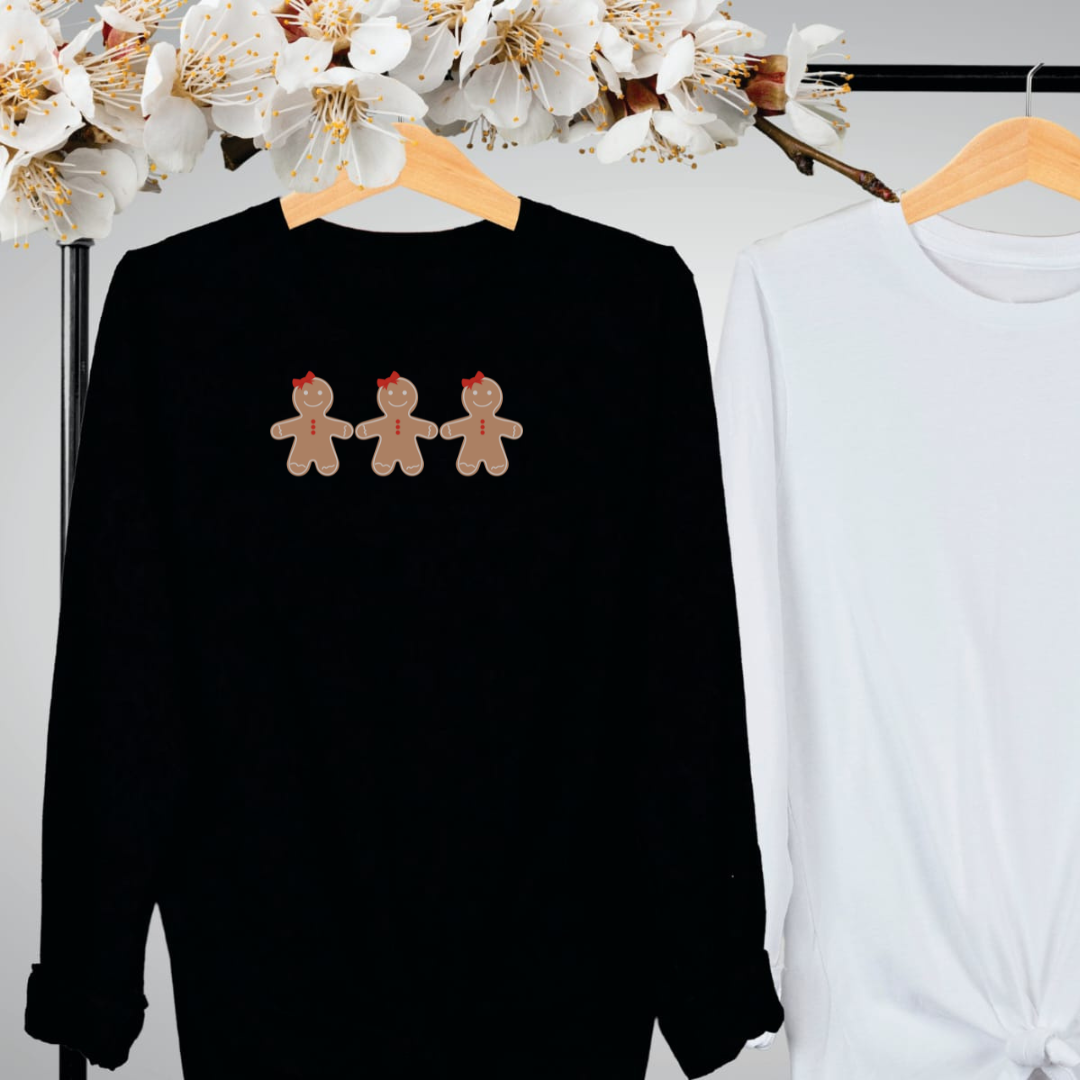 "Gingerbread cookies graphic design centered on black long sleeve shirt."