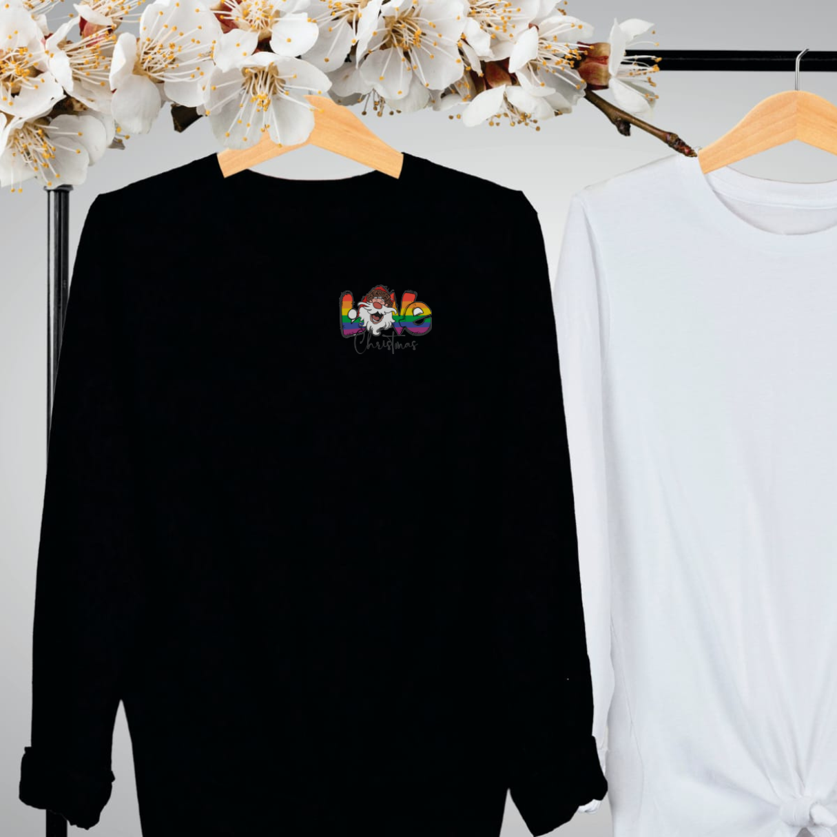 "Pride love Christmas text design centered on black long sleeve shirt."