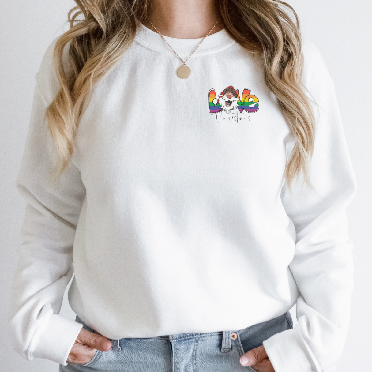"Pride love Christmas text design centered on white sweater."