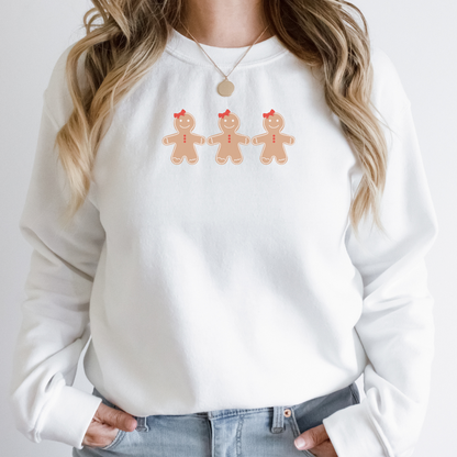 "Gingerbread cookies graphic design centered on white sweater."