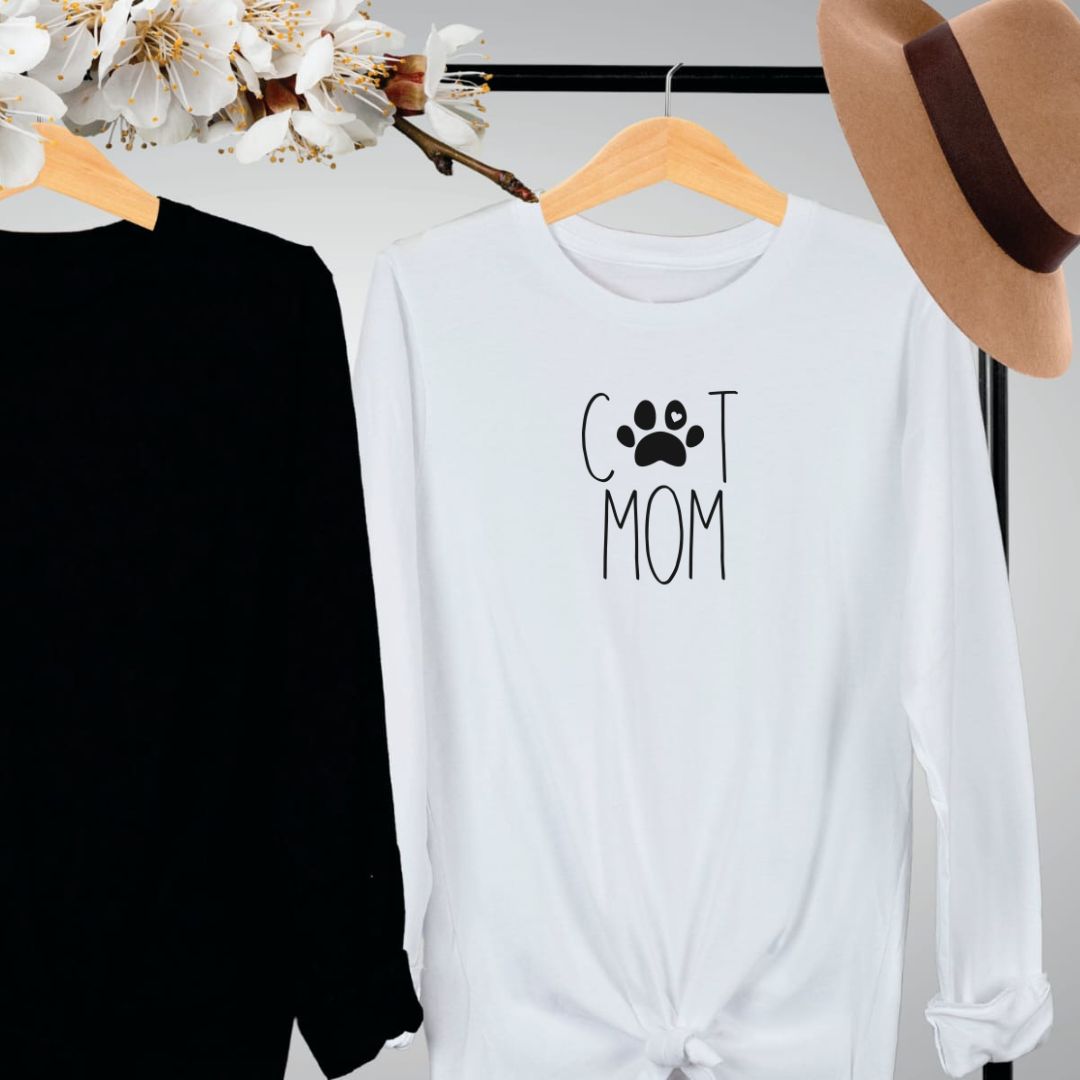 "Cat mom text design centered on white long sleeve shirt."