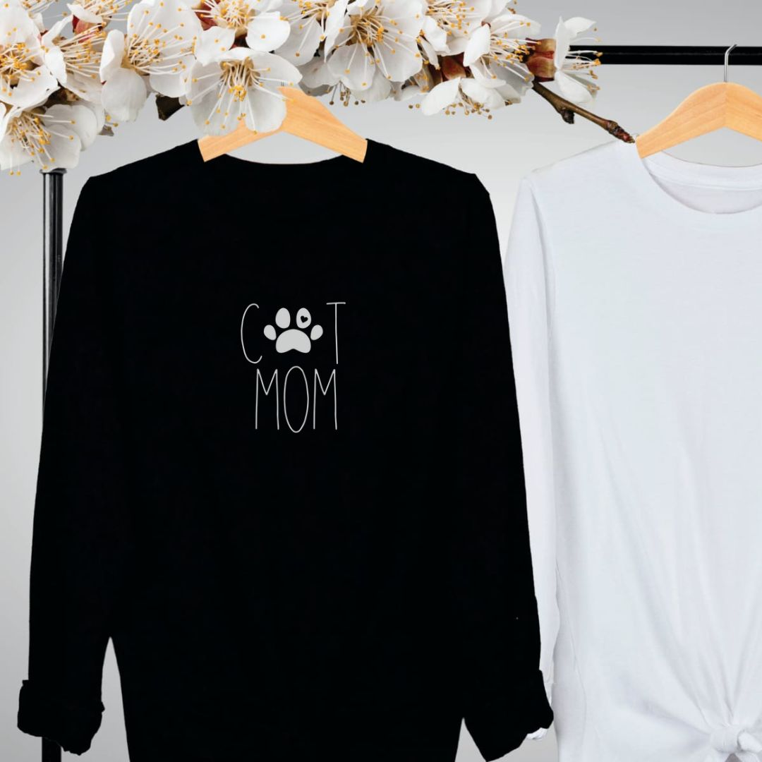 "Cat mom text design centered on black long sleeve shirt."