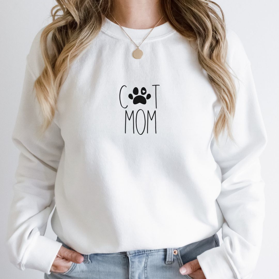 "Cat mom text design centered on white sweater."