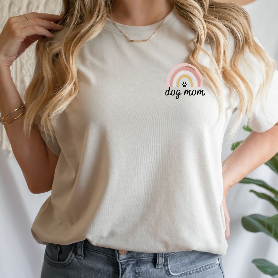 "Dog mom rainbow text and graphic design left pocket position on natural t-shirt"