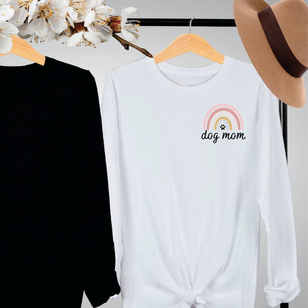 "Dog mom rainbow text and graphic design left pocket position on white long sleeve shirt."