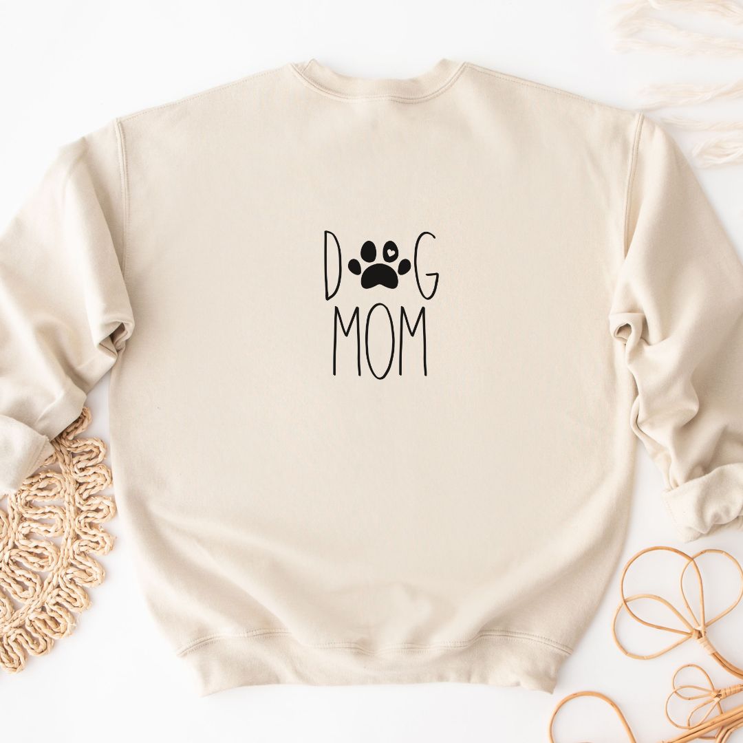 "Dog mom text design centered on natural sweater."