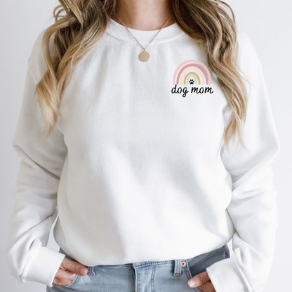 "Dog mom rainbow text and graphic design left pocket position on white sweater."