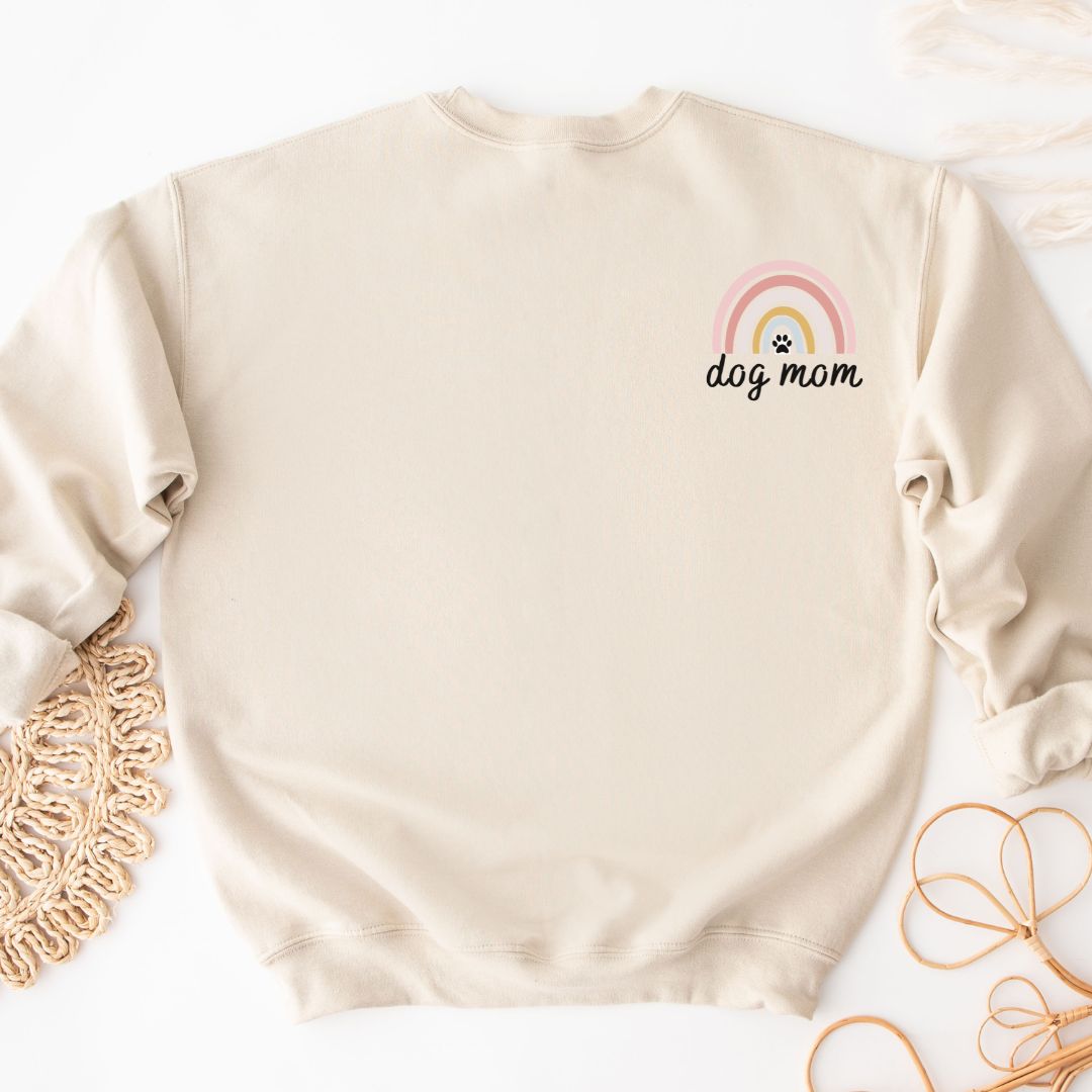 "Dog mom rainbow text and graphic design left pocket position on natural sweater."