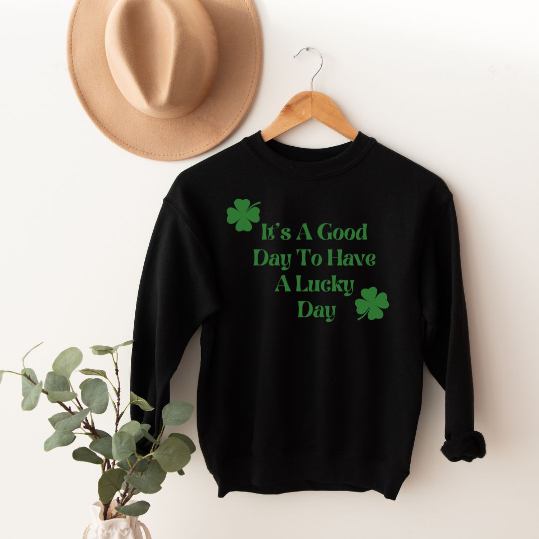 "Lucky Day text design centered on black sweater."