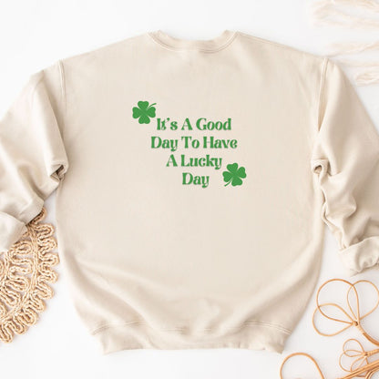 "Lucky Day text design centered on natural sweater."