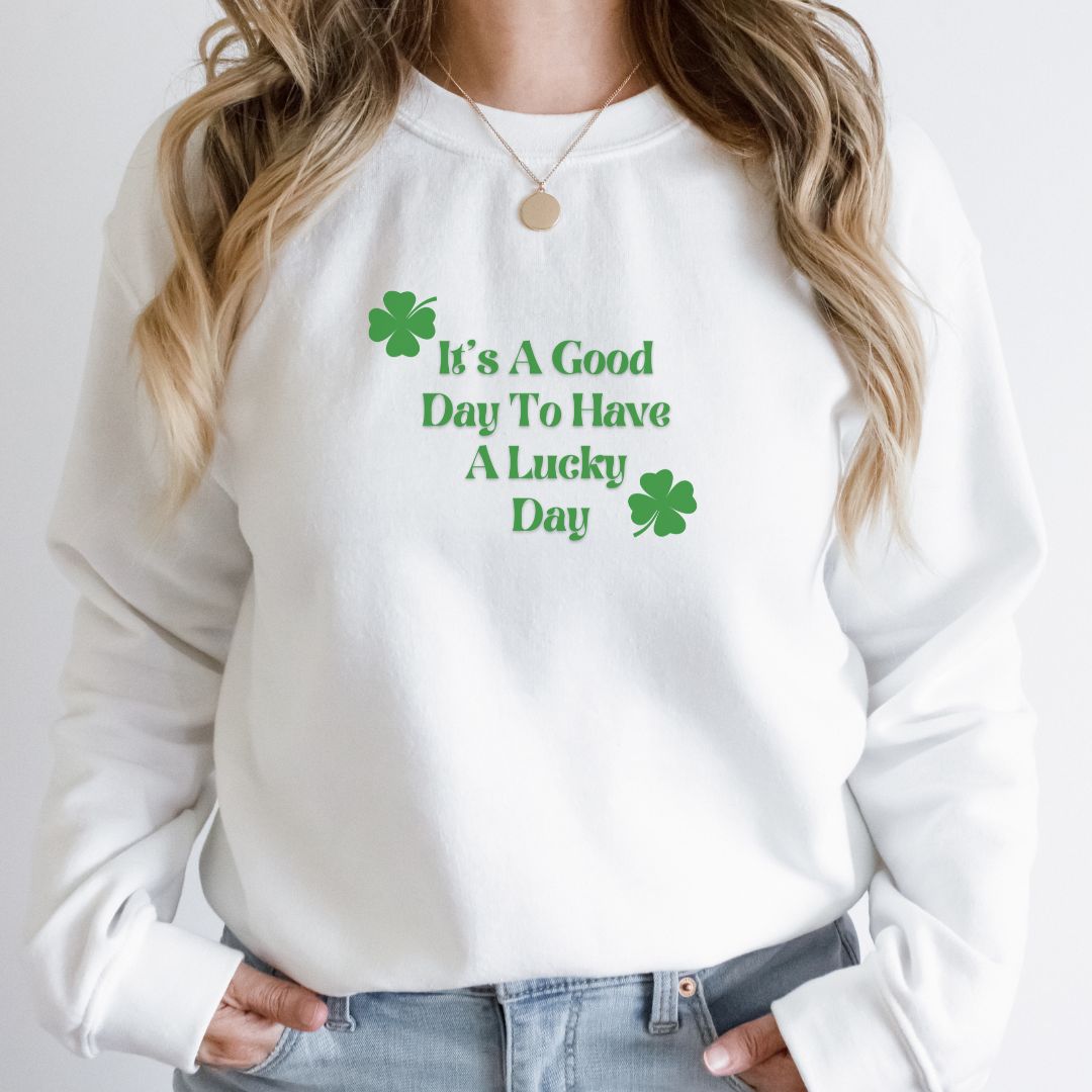 "Lucky Day text design centered on white sweater."
